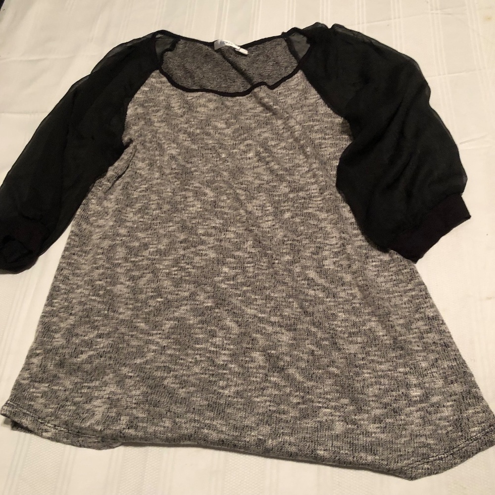 Ricki’s xl shirt, sleeves are see through black. Round neck. New or like new
